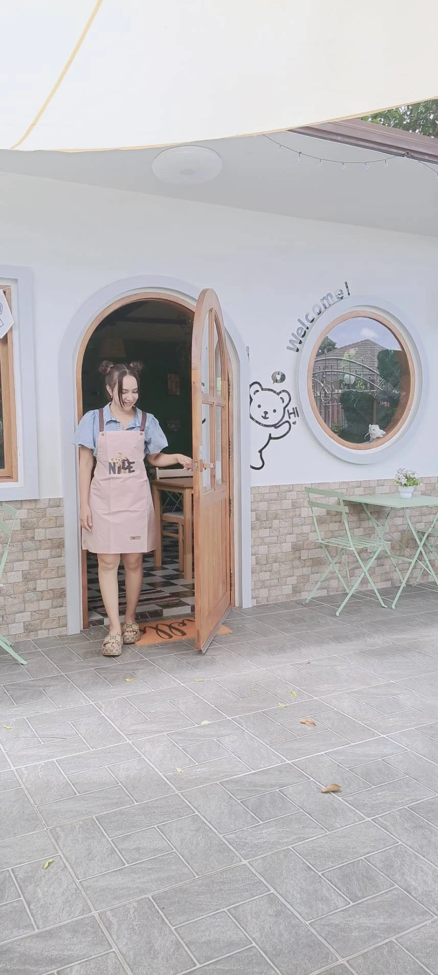 Piyarot welcoming guests at the entrance of PIYA Café